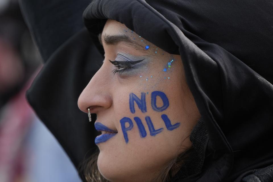 Elise Ketch of northern Virginia protests outside the Supreme Court as it heard oral arguments over access to mifepristone.