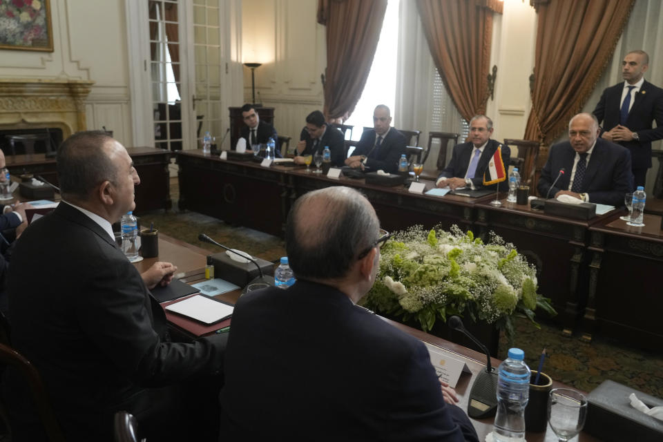 Egyptian Foreign Minister Sameh Shoukry, right, meets with his Turkish counterpart Mevlut Cavusoglu, left, and his delegations at Tahrir Palace in Cairo, Egypt, Saturday, March 18, 2023. The meeting is the first such high-level in more than a decade as the countries repair relations damaged in the wake of the 2011 Arab Spring. (AP Photo/Amr Nabil)