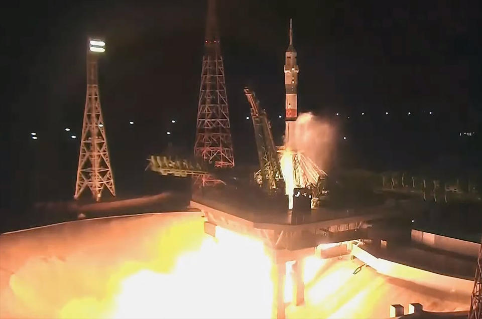 A white and green Russian rocket launches into the night sky on Sept. 15, 2023
