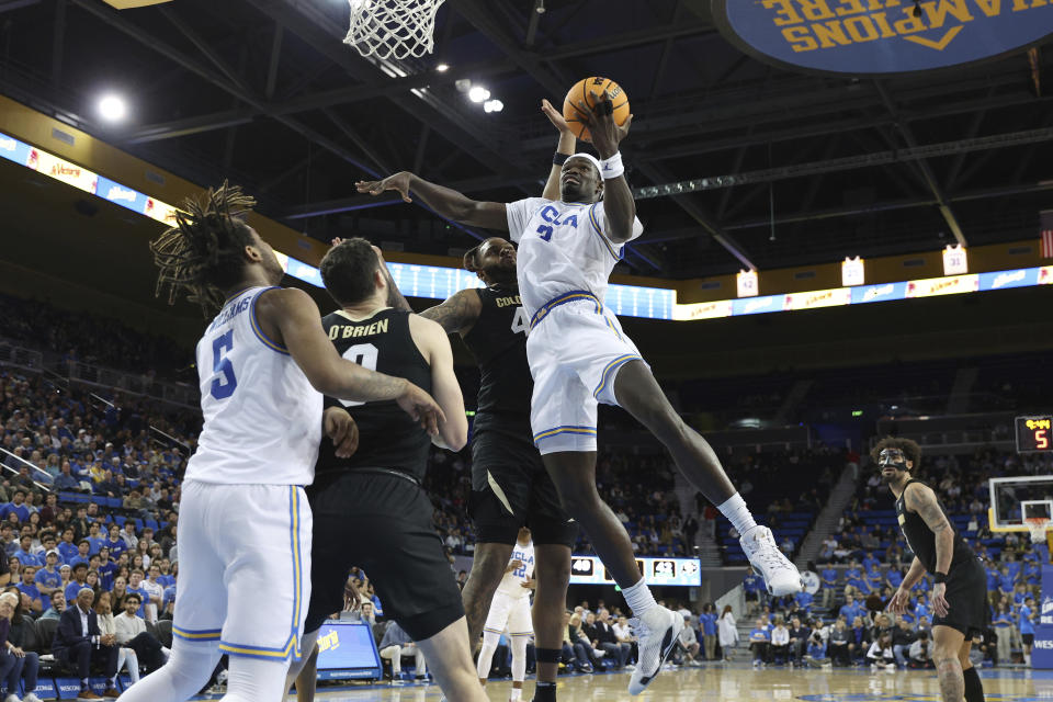 UCLA forward Adem Bona, front right, lays up the ball while defended by Colorado center Eddie Lampkin Jr., center back, during the second half of an NCAA college basketball game Thursday, Feb. 15, 2024, in Los Angeles. (AP Photo/Raul Romero Jr.)