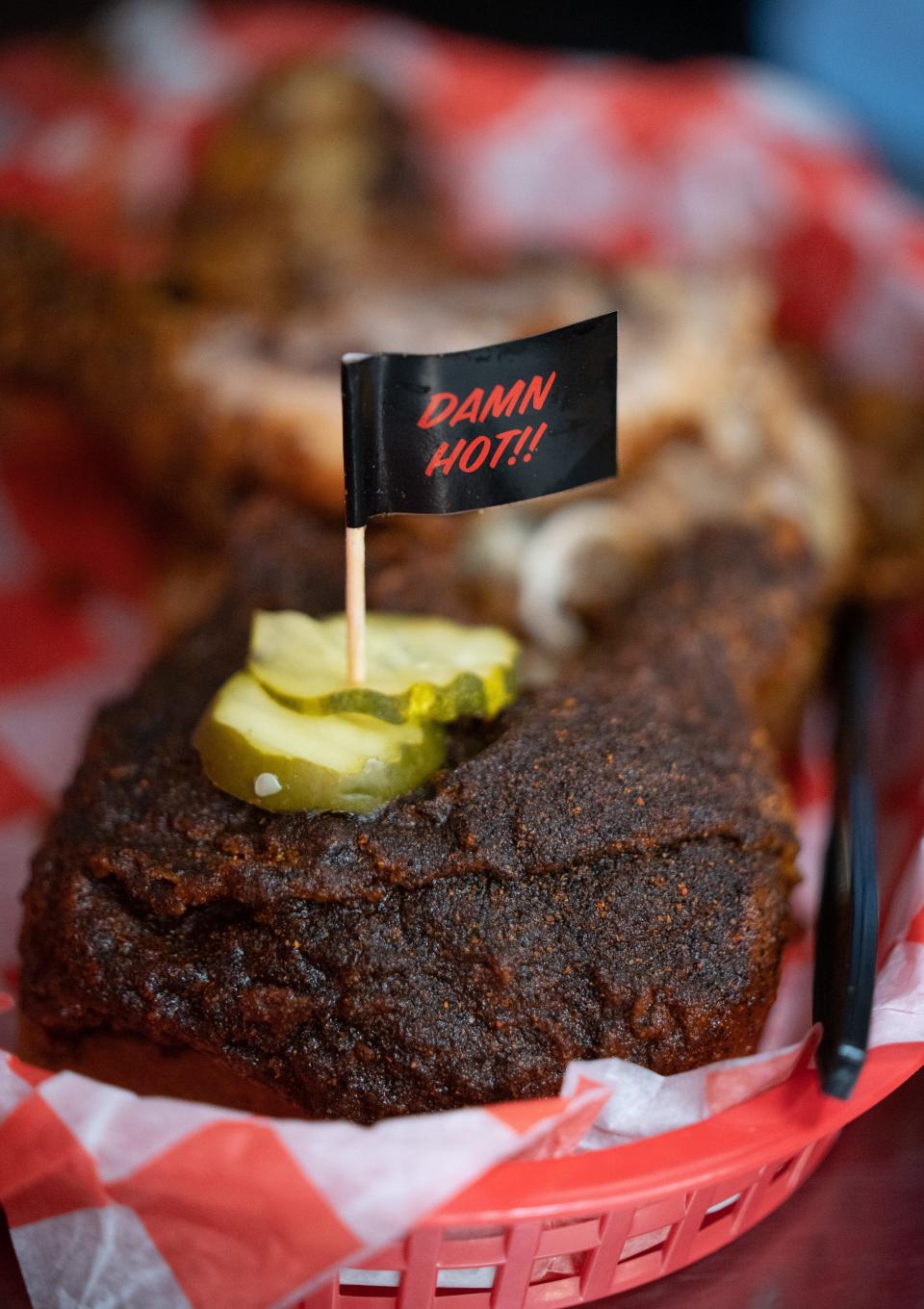 Jessica Benson's "Damn Hot" chicken at Hattie B's Hot Chicken Midtown in Nashville, Tenn., Tuesday, April 2, 2024. She's also a fan of the "Shut the Cluck Up" chicken which she says makes the chicken even juicier.