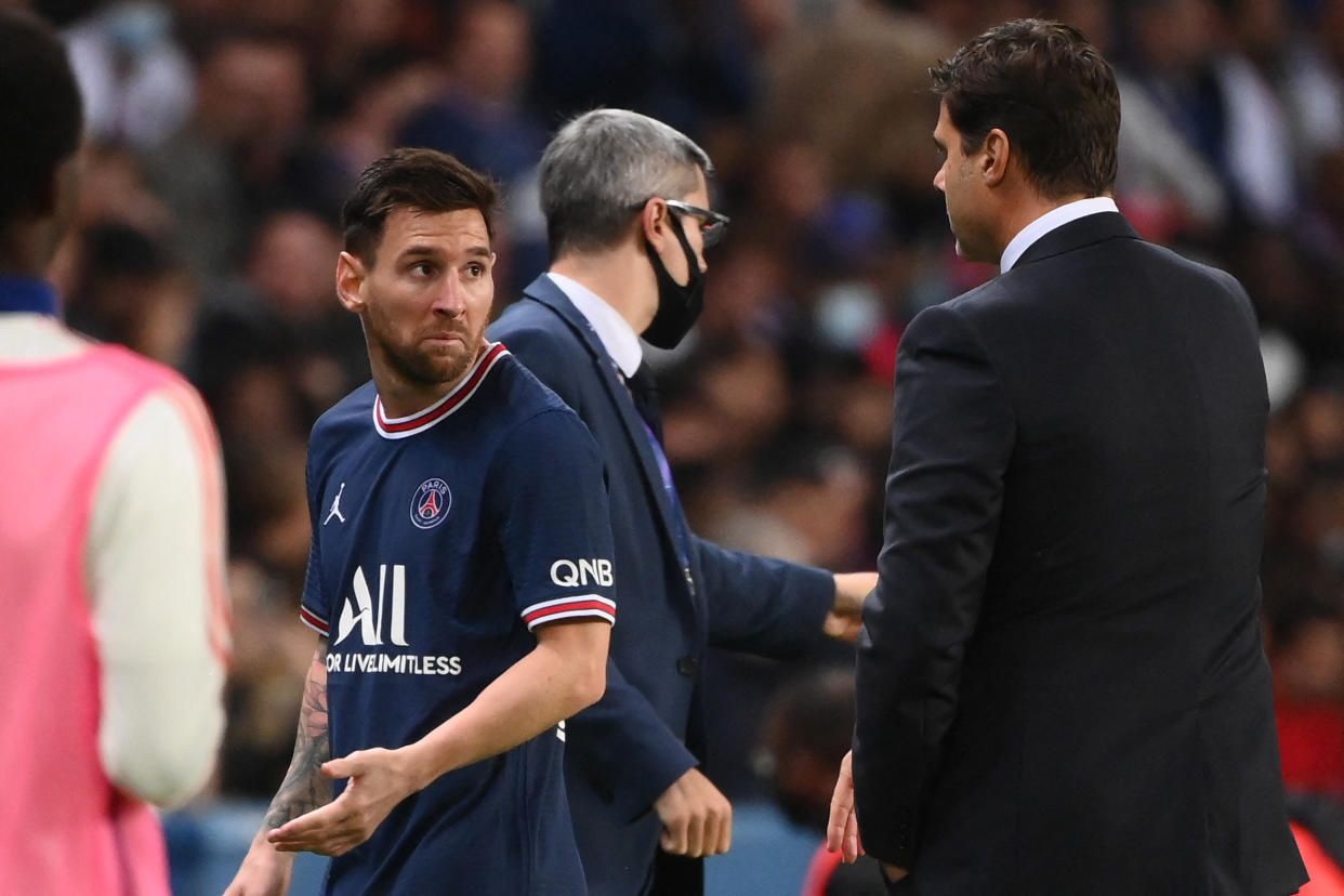 Paris Saint-Germain's Argentinian forward Lionel Messi (L0 leaves the pitch after chatting with Paris Saint-Germain's Argentinian head coach Mauricio Pochettino during the French L1 football match between Paris-Saint Germain (PSG) and Olympique Lyonnais at The Parc des Princes Stadium in Paris on September 19, 2021. (Photo by FRANCK FIFE / AFP) (Photo by FRANCK FIFE/AFP via Getty Images)