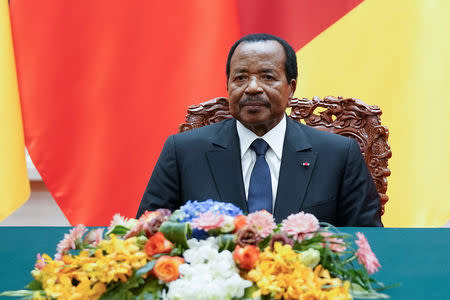 FILE PHOTO: President of Cameroon Paul Biya with Chinese President Xi Jinping (not pictured) attend a signing ceremony at The Great Hall Of The People in Beijing, China March 22, 2018. Lintao Zhang/Pool via Reuters/File Photo