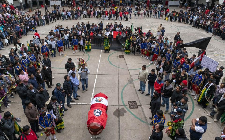 Mourners gather around Remo Candia's coffin during a ceremony in Cusco, Peru - Michael Bednar/Getty Images