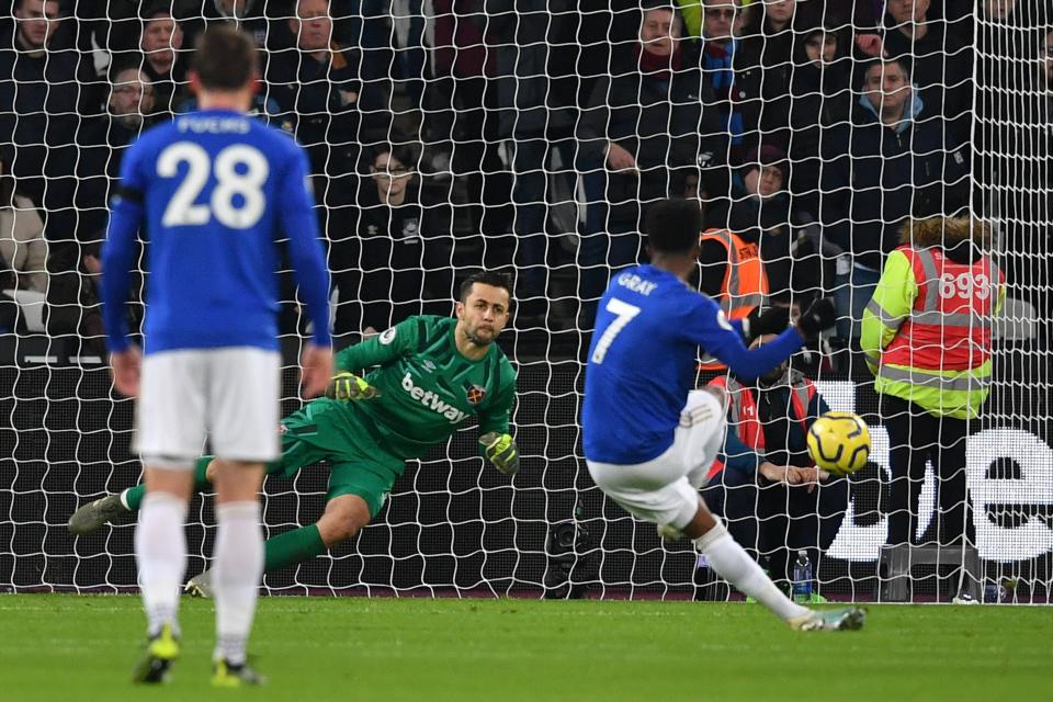 West Ham United's Polish goalkeeper Lukasz Fabianski dives to save a penalty taken by Leicester City's English midfielder Demarai Gray (R) during the English Premier League football match between West Ham United and Leicester City at The London Stadium, in east London on December 28, 2019. (Photo by Ben STANSALL / AFP) / RESTRICTED TO EDITORIAL USE. No use with unauthorized audio, video, data, fixture lists, club/league logos or 'live' services. Online in-match use limited to 120 images. An additional 40 images may be used in extra time. No video emulation. Social media in-match use limited to 120 images. An additional 40 images may be used in extra time. No use in betting publications, games or single club/league/player publications. /  (Photo by BEN STANSALL/AFP via Getty Images)