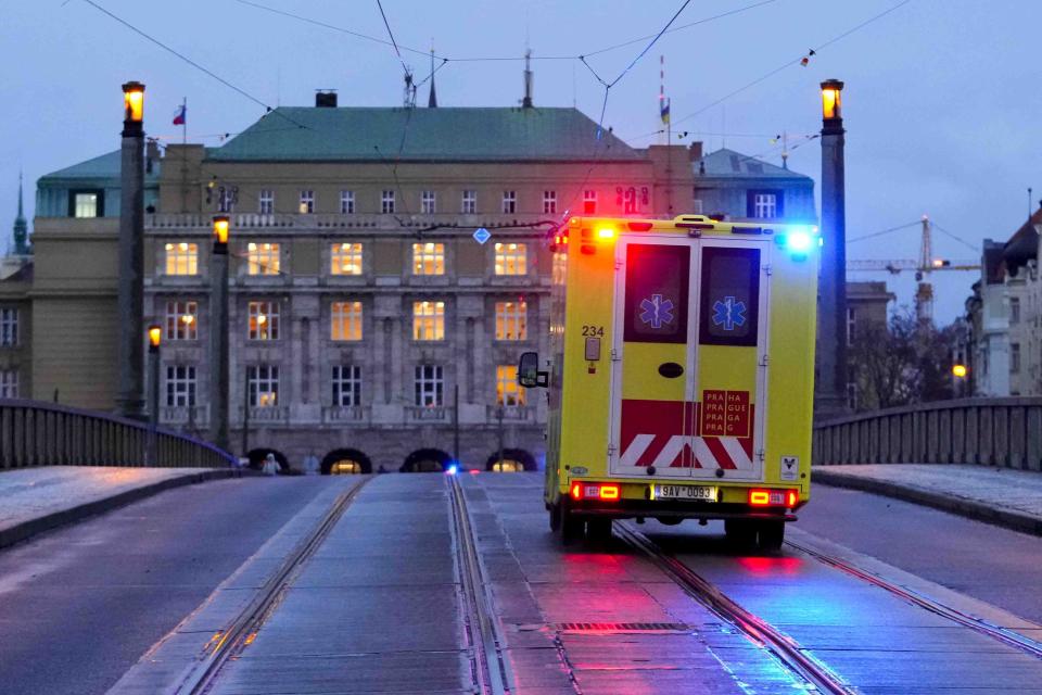 An ambulance drives towards the building of Philosophical Faculty of Charles University in downtown Prague, Czech Republic, Thursday, Dec. 21, 2023. Czech police say a shooting in downtown Prague has killed an unspecified number of people and wounded others. (AP Photo/Petr David Josek)