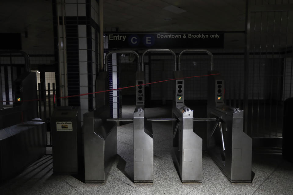 An entrance to the C and E trains at the 50th Street Subway Station is dimly lit during a power outage, Saturday, July 13, 2019, in New York. Authorities were scrambling to restore electricity to Manhattan following a power outage that knocked out Times Square's towering electronic screens and darkened marquees in the theater district and left businesses without electricity, elevators stuck and subway cars stalled. (AP Photo/Michael Owens)