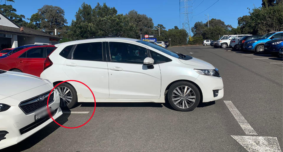 Honda hatchback parking incorrectly in car park