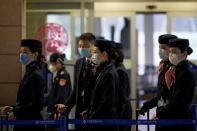 Flight crew members wear masks at the Pudong International Airport in Shanghai