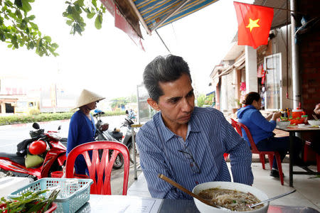 Vietnamese deportee and Amerasian Pham Chi Cuong, 47, who was deported from U.S., eats along a street in central Ho Chi Minh City, Vietnam April 20, 2018. REUTERS/Kham