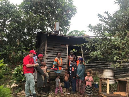 International Federation of Red Cross and Red Crescent Societies members talk to people after an earthquake and aftershocks in Nipa-Kutubu district, Papua New Guinea March 6, 2018. International Federation of Red Cross and Red Crescent Societies (IFRC) / via REUTERS