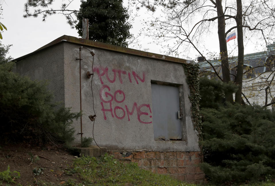 A sign is painted on the wall by the Russian Embassy in Prague, Czech Republic, Thursday, April 22, 2021. The Czech Republic on Thursday ordered more Russian diplomats to leave the country, further escalating a fierce tug-of-war between the two nations over the alleged involvement of Russian spies in a massive ammunition depot explosion in 2014. (AP Photo/Petr David Josek)