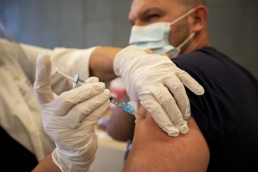 LOS ANGELES, CA - DECEMBER 17: Dr Chris Major is given the SARS-CoV-2 vaccination at Martin Luther King, Jr. Community Hospital took place on Thursday, Dec. 17, 2020 in Los Angeles, CA. Martin Luther King Jr. Community Hospital (MLKCH) received 690 doses of the Pfizer vaccine, followed by another 690 21 days later. The vaccine must be administered twice to be effective. MLKCH staff with direct and frequent exposure to patients with COVID-19 will be prioritized, per CDPH guidelines. (Francine Orr / Los Angeles Times)