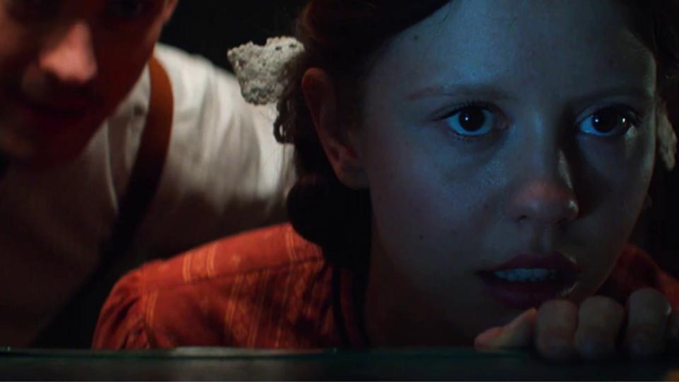 Pearl (Mia Goth) watches an early dirty movie in the prequel to X.