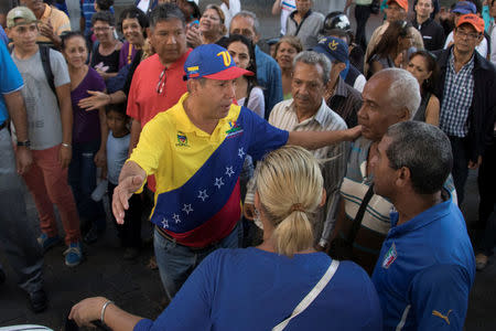 Venezuelan presidential candidate Henri Falcon speaks with people during a campaign event at the slum of Catia in Caracas, Venezuela April 2, 2018. REUTERS/Rayner Pena