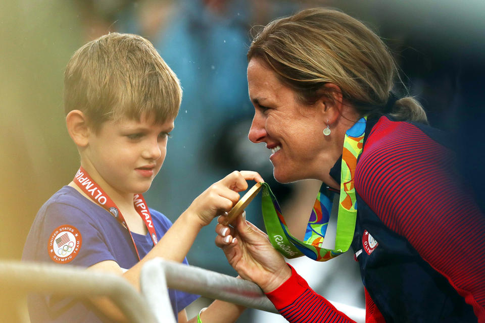 <p>Gold medalist Kristin Armstrong of the United States shows her medal to her son Lucas William Savola after the medal ceremony for the Cycling Road Women’s Individual Time Trial on Day 5 of the Rio 2016 Olympic Games at Pontal on August 10, 2016 in Rio de Janeiro, Brazil. (Photo by Bryn Lennon/Getty Images) </p>