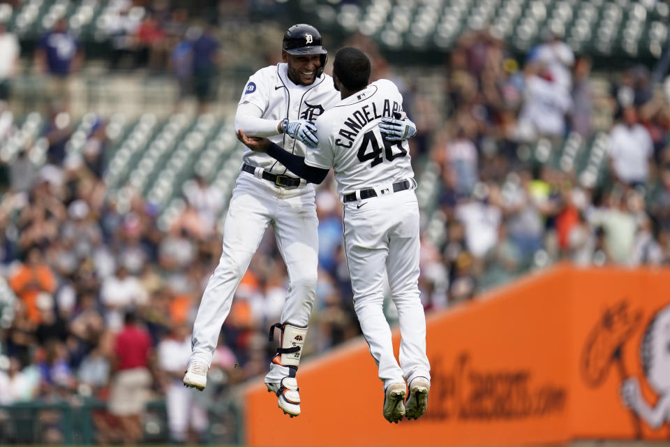 Detroit Tigers' Victor Reyes, left, celebrates his two-run double with Jeimer Candelario (46) against the San Diego Padres in the ninth inning of a baseball game in Detroit, Wednesday, July 27, 2022. Detroit won 4-3. (AP Photo/Paul Sancya)
