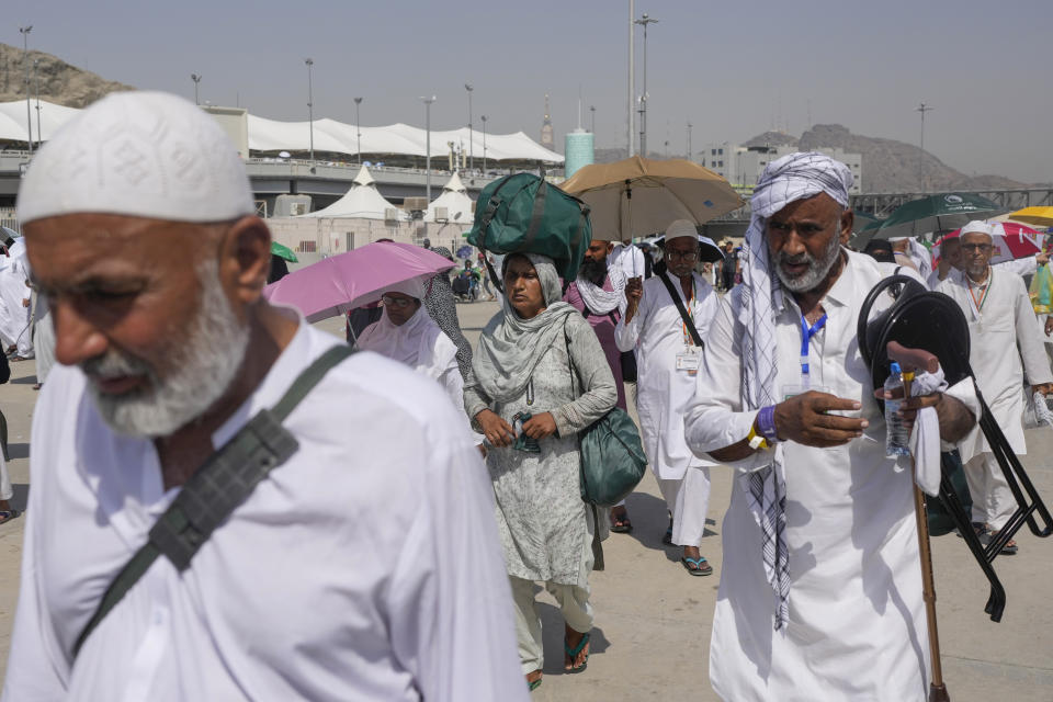 Muslim pilgrims arrive to cast stones at pillars in the symbolic stoning of the devil, the last rite of the annual hajj, in Mina, near the holy city of Mecca, Saudi Arabia, Tuesday, June 18, 2024. Muslim pilgrims were wrapping up the Hajj pilgrimage in the deadly summer heat on Tuesday with the third day of the symbolic stoning of the devil, and the farewell circling around Kaaba in Mecca's Grand Mosque. (AP Photo/Rafiq Maqbool)