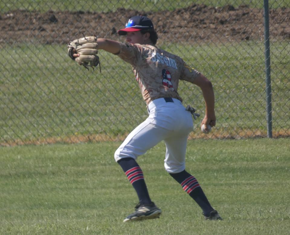 Newark Catholic's Shawn Leach sets to make a throw from left field for the Athletics 16U against the Ohio Stingers 16U/17U during the Can of Corn Prospect Tournament at Newark High School on Saturday, July 2, 2022. The Stingers beat the A's 4-1.