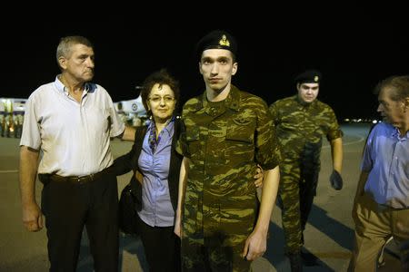 Angelos Mitretodis, one of the two Greek soldiers who were detained in Turkey after crossing the border, is welcomed by his parents after being released, at the airport of Thessaloniki, Greece, August 15, 2018. REUTERS/Alexandros Avramidis