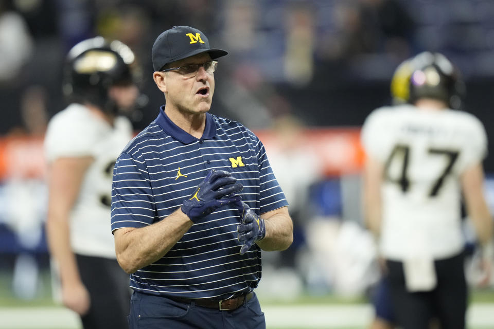 FILE - Michigan head coach Jim Harbaugh watches before the start of the Big Ten championship NCAA college football game against Purdue, Saturday, Dec. 3, 2022, in Indianapolis. Michigan coach Jim Harbaugh has informed his team and staff that he will serve a three-game suspension to start this season as part of the school’s self-imposed penalties for NCAA infractions, two people familiar with the situation told The Associated Press on Monday, Aug. 21, 2023. (AP Photo/AJ Mast, File)