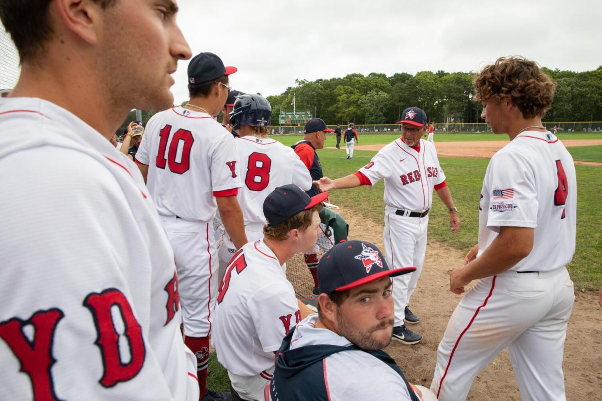 Coach Scott Pickler talks to his team in the dugout.