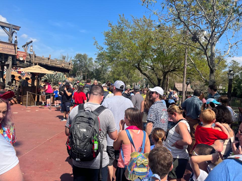 crowds and lines outside thunder mountain at magic kingdom in disney world