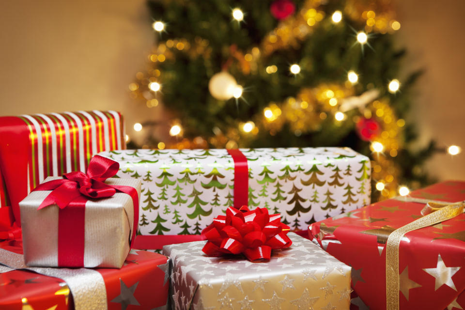 Presents in front of a Christmas tree