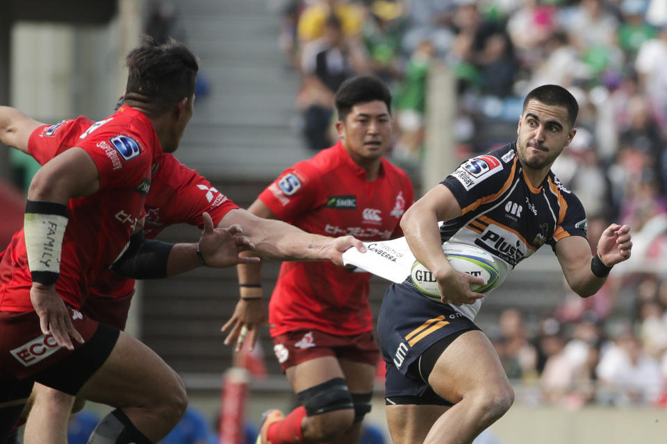Sunwolves' Mark Abbott, left, grabs the jersey of Brumbies' Tom Wright during the second half of a Super Rugby game Saturday, June 1, 2019, in Tokyo. (AP Photo/Jae C. Hong)
