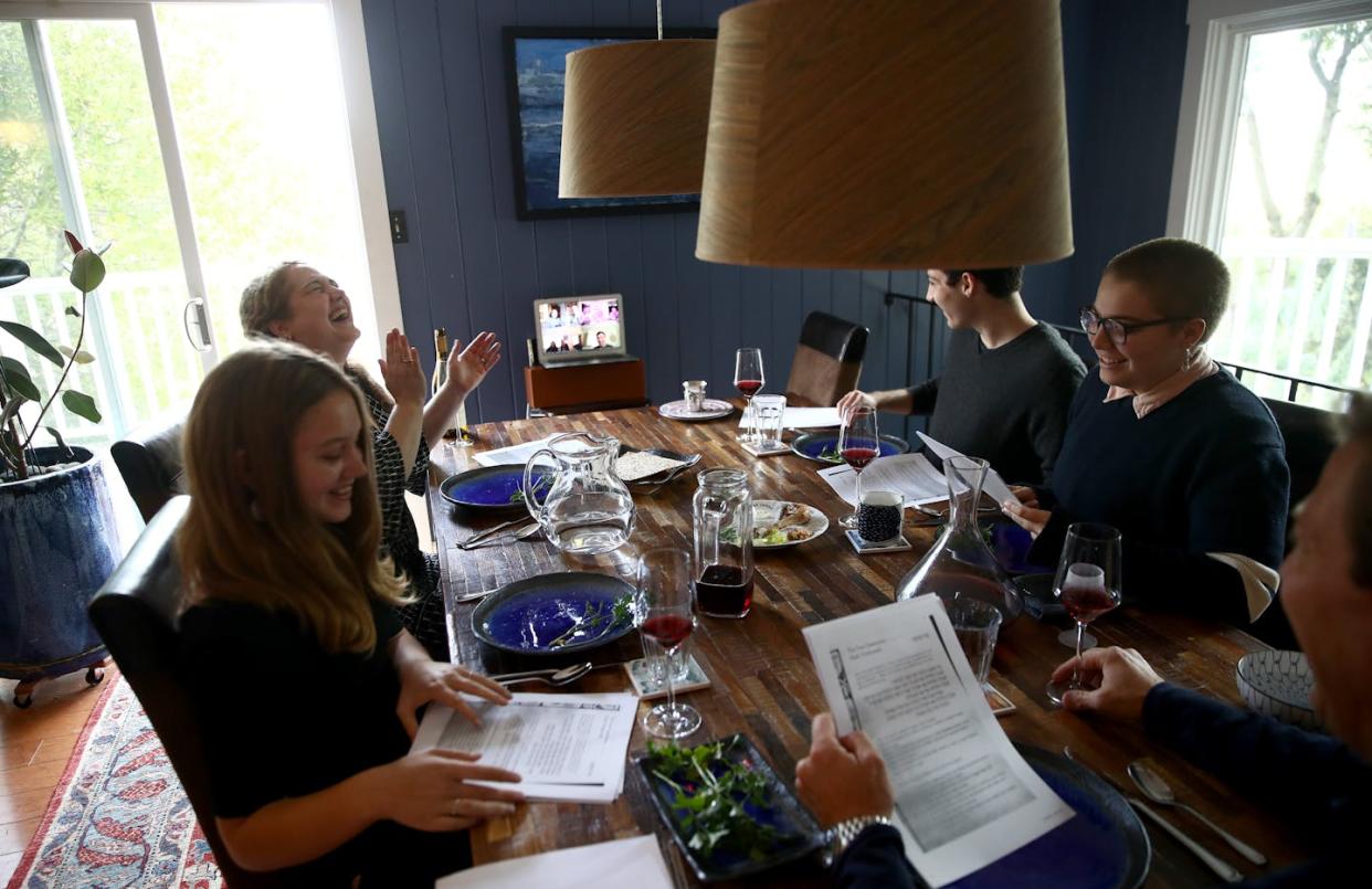 A Jewish family gathers in person and over video conferencing for Passover celebrations in 2020. <a href="https://www.gettyimages.com/detail/news-photo/sarah-and-aaron-sanders-celebrate-a-passover-seder-with-news-photo/1217699457?adppopup=true" rel="nofollow noopener" target="_blank" data-ylk="slk:Ezra Shaw/Getty Images;elm:context_link;itc:0;sec:content-canvas" class="link ">Ezra Shaw/Getty Images</a>