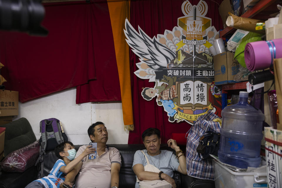 Supporters sit at Hong Kong's pro-democracy Citizens' Radio station prior to the radio's last broadcast in Hong Kong, Friday, June 30, 2023. (AP Photo/Louise Delmotte)
