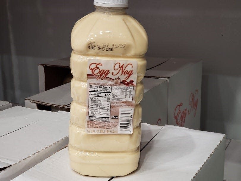 clear bottle of eggnog on top of white boxes at Costco