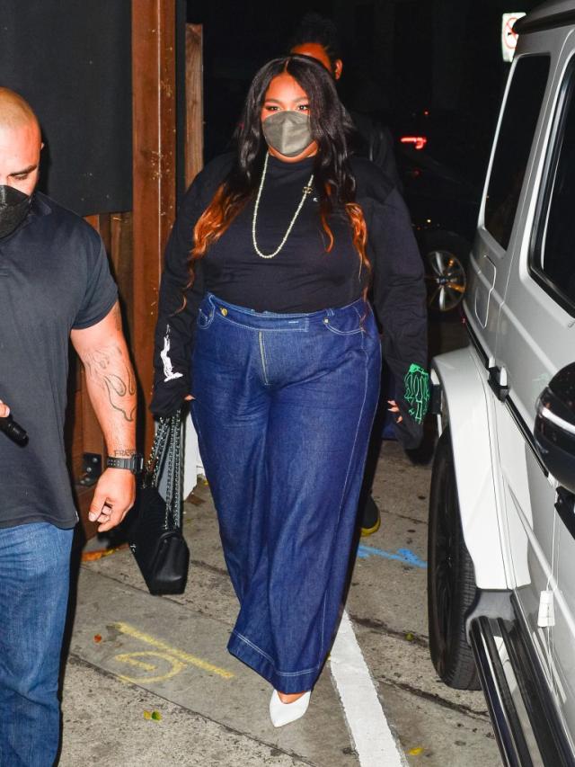 Lizzo Sharpens Up for Dinner in High-Waisted Jeans, Chanel Pearls and White  Reptilian Pumps