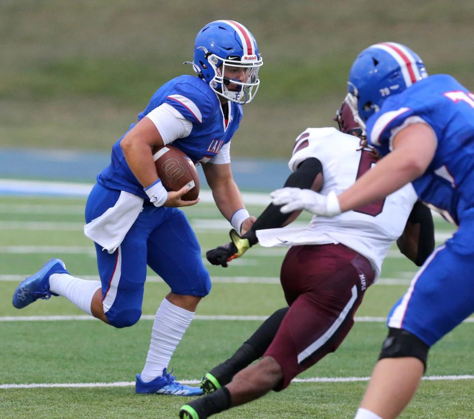 Lake's Cale Jarvis takes off on a run during a high school football game against Maple Heights at Lake on Friday, August 26, 2022.