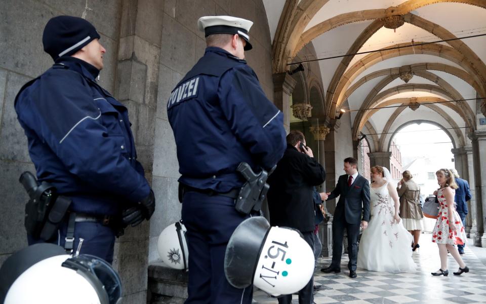 German police guard a wedding at the historical town hall next to the AfD party conference  - Credit: EPA