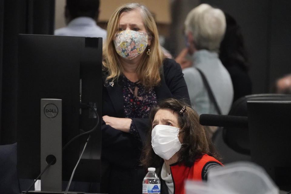 Democratic and Republican representatives review absentee ballots at the Fulton County Election preparation Center Wednesday, Nov. 4, 2020, in Atlanta. (AP Photo/John Bazemore)