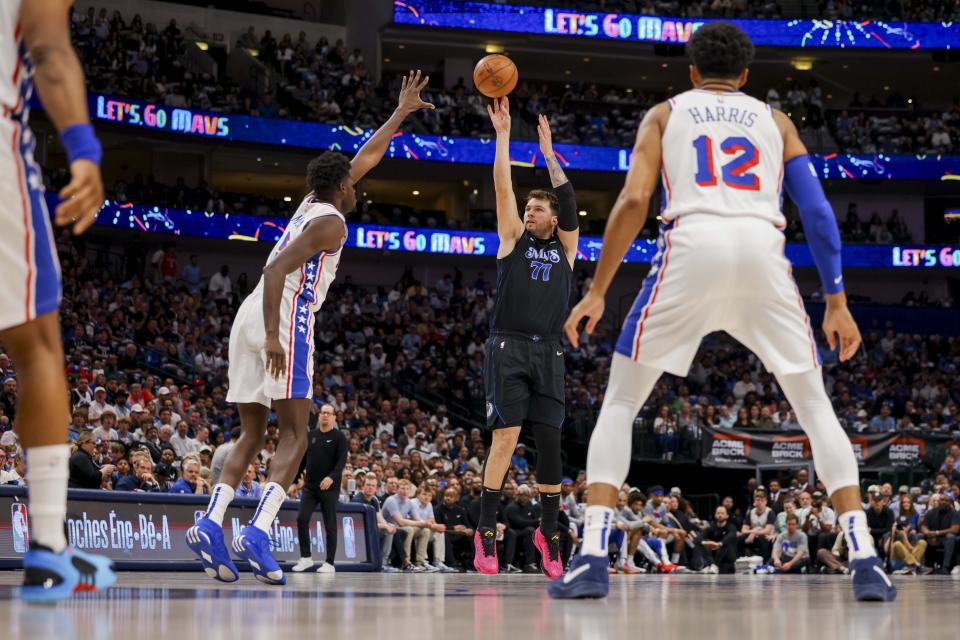 Dallas Mavericks guard Luka Doncic (77) shoots over Philadelphia 76ers center Mo Bamba (5) during the first half of an NBA basketball game Sunday, March 3, 2024, in Dallas. (AP Photo/Gareth Patterson)