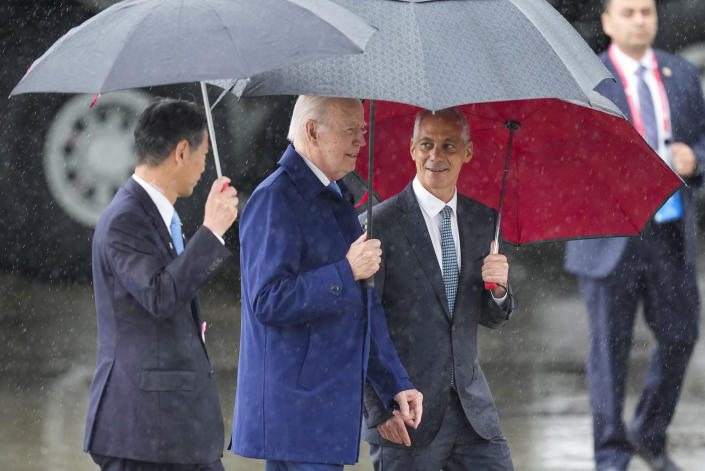 CORRECTS NAME OF THE MAN AT LEFT - U.S. President Joe Biden, center, walks with Kenji Yamada, Japanese deputy minister of foreign affairs, left, and U.S. Ambassador to Japan Rahm Emanuel, right, after his arrival at Marine Corps Air Station Iwakuni, western Japan, Thursday, May 18, 2023, en route to Hiroshima for the Group of Seven nations' summit that starts Friday. (AP Photo/Hiro Komae)