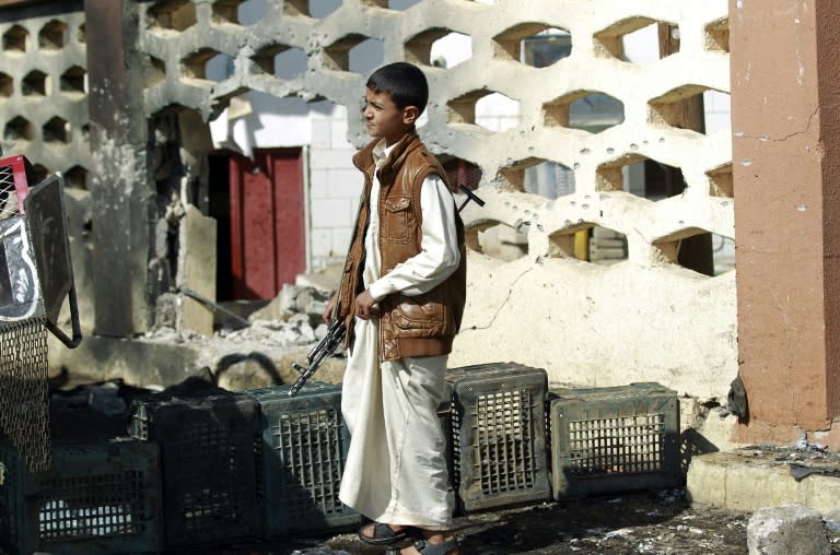 A youth in front of the Al-Nour mosque after it was targeted by a suicide bombing on October 7, 2015