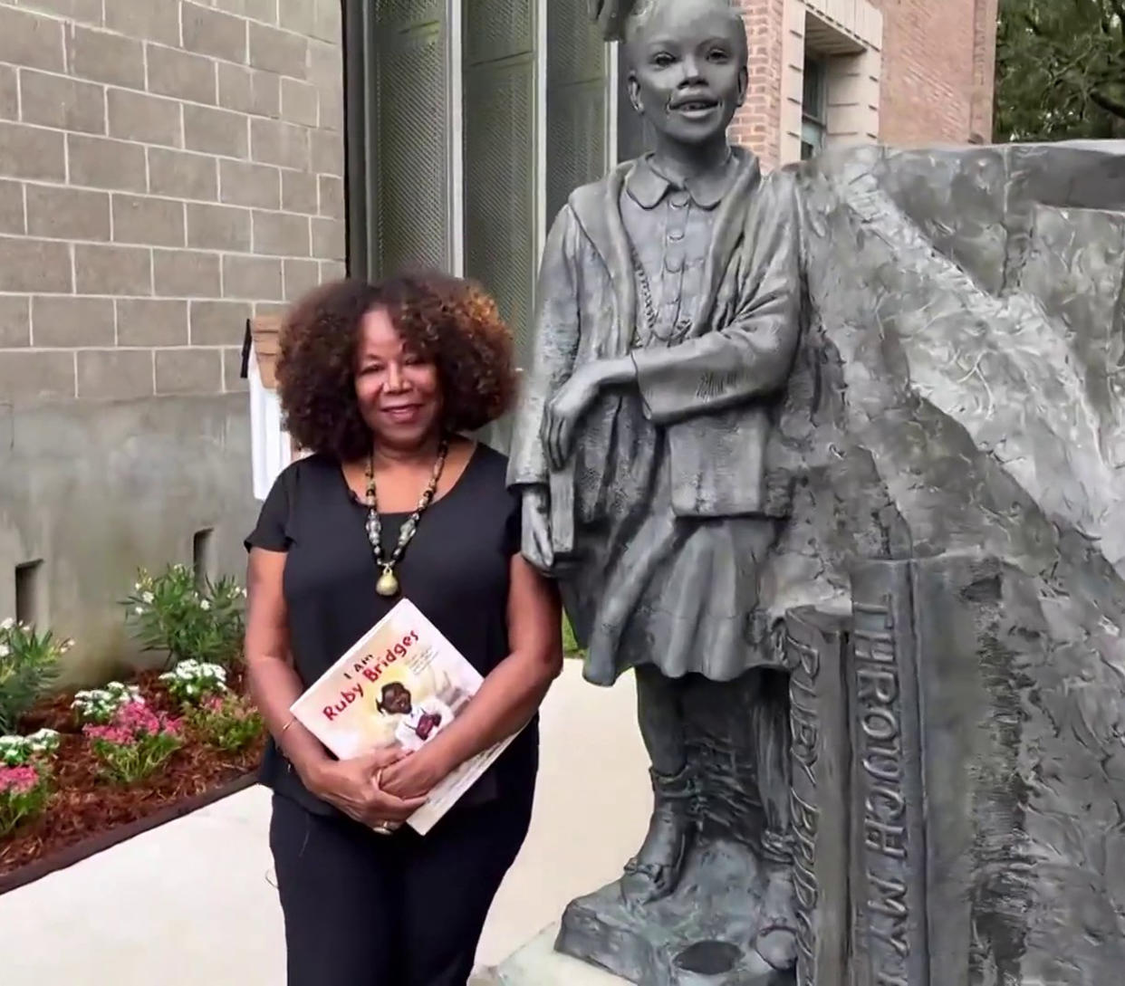 Ruby Bridges today, next to a statue of her as a girl. (TODAY)