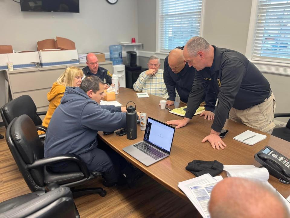 Mayor James Dodd, standing at center, meets with Dover officials to prepare for a flooding rain storm on January 9.