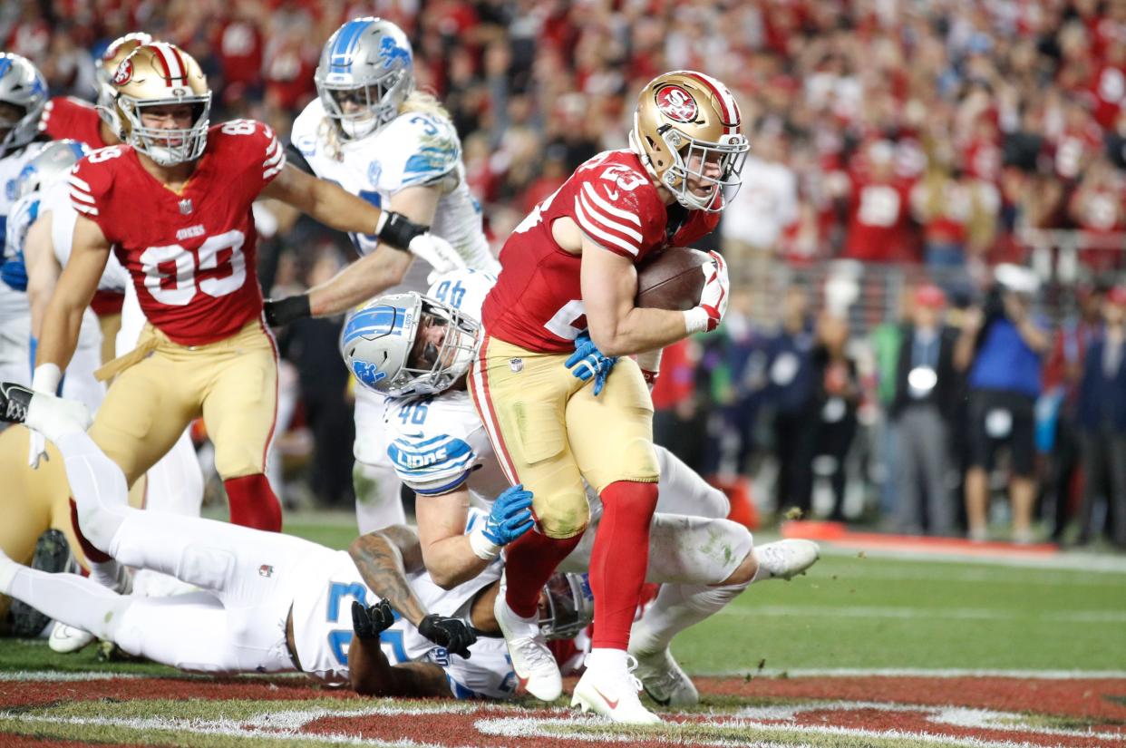 49ers running back Christian McCaffrey runs the ball in for a touchdown in the third quarter of the Lions' 34-31 loss in the NFC championship game in Santa Clara, California, on Sunday, Jan. 28, 2024.
