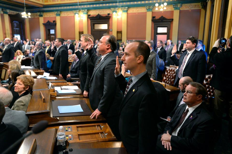 State representatives sworn in with the rest of the House members on the House floor during the opening of the 98th Legislature in Lansing. If voters adopt Proposal 1 in the Nov. 8, 2022 election, state lawmakers would go from serving up to 14 years in the Legislature to 12 years, but they could serve all 12 years in either the state House or the state Senate.