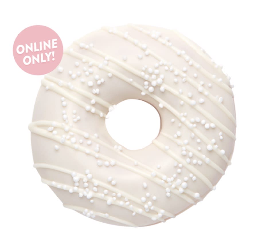 A white frosted, white drizzled, pearl sugared donut