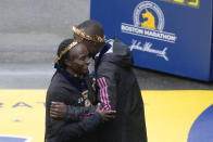 Hellen Obiri, left, and Evans Chebet, both of Kenya, embrace after winning the men's and women's division of the Boston Marathon, Monday, April 17, 2023, in Boston. (AP Photo/Charles Krupa)