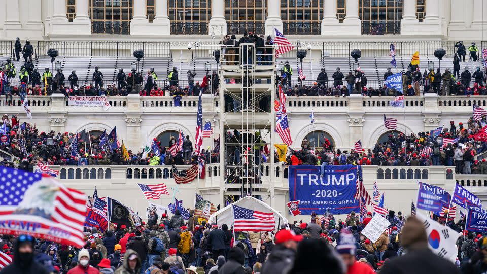 Insurrectionists loyal to President Donald Trump breach the US Capitol in Washington, DC, on January 6, 2021. - John Minchillo/AP/File