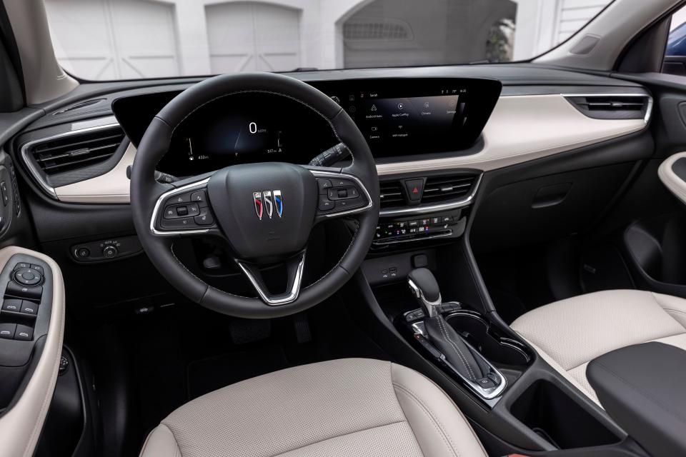 A view of the driver’s seat in 2024 Buick Encore GX Avenir with Whisper Beige and Jet Black interior. Preproduction model shown. Actual production model may vary. Available in spring 2023.