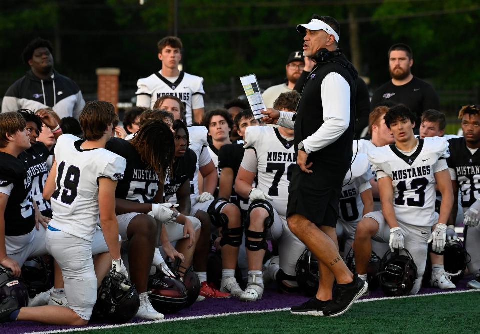 Lipscomb Academy head football coach Kevin Mawae talks with his players after a spring scrimmage Friday, May 12, 2023, in Nashville, Tenn.