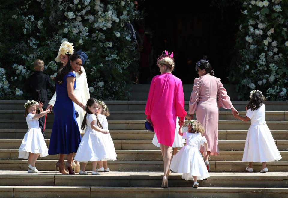 Jessica Mulroney (in blue) holds hands with a bridesmaid and young daughter, Ivy.