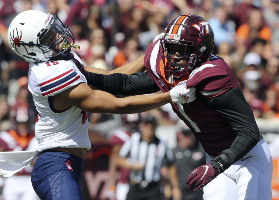 Richmond's Isaac Brown (15) battles for position with Virginia Tech defensive back Chamarri Conner (1) in the first half of the Richmond Virginia Tech NCAA college football game in Blacksburg, Va., Saturday, Sept. 25 2021. (Matt Gentry/The Roanoke Times via AP)